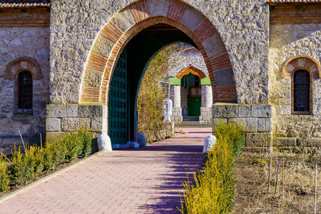 Stone arch at the entrance to the old stone church. Background with selective focus and copy space for text. Classic vintage architectureの写真素材
