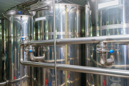 A stainless steel vat in the food industry at a brewery in the process of brewing beer. Background...