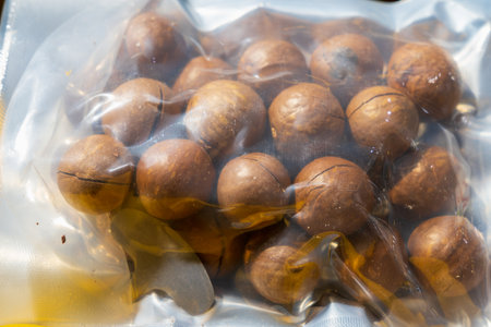 Macadamia nut in shell with opener. Background with selective focus and copy space for textの写真素材