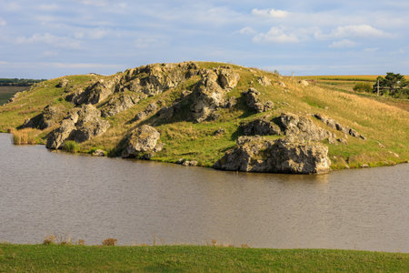 Wild rocky and mountainous nature of Eastern Europe. Landscape background with copy space for text. Selective focus, toned. Village Konstantinovka, welcome to Moldova.の写真素材