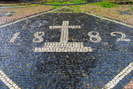 The inscription 1882 and a cross made of multi-colored street paving slabs. Background with selective focus and copy space for textの写真素材