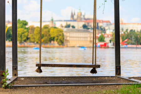 Swing by the river. Background with selective focus and copy space for textの写真素材