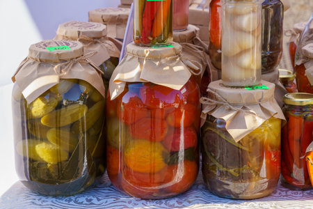 Homemade pickles in jars on the counter of the city fair. November 11, 2021 Balti Moldova. For editorial illustrative use. Background with copy space for textのeditorial素材