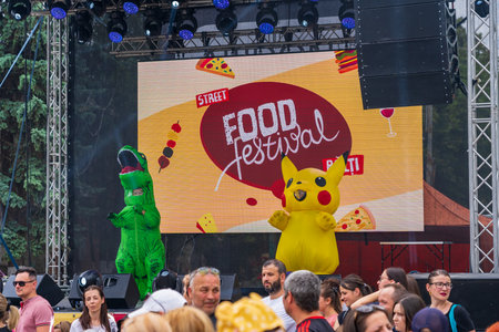 Animators at work at a street food festival. Pikachu. Entertainment for tourists and citizens. June...