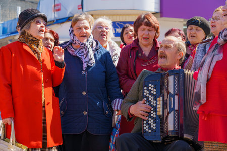 April 15, 2022 Balti Moldova, Protest rally against the ban on the St. George Ribbon. Pensioners sing patriotic songs to the accordion. Illustrative editorial backgroundのeditorial素材