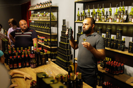 Olive oil seller at work. Selective focus. Background with copy space for text. Illustrative editorial. August 9, 2022 Kuzdere, Antalya Province, Turkeyのeditorial素材