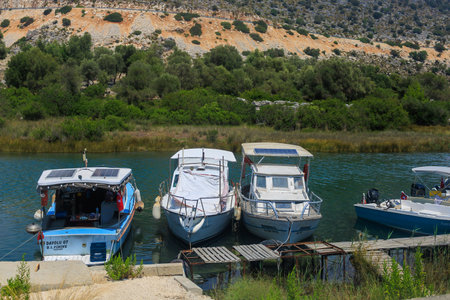 A small port in the Turkish bay with pleasure yachts on the rocky coast of the Mediterranean Sea. August 10, 2022 Demre, Antalya province, Turkey.のeditorial素材