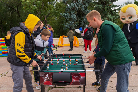 Children play table football in an urban environment at a city holiday. For editorial use. October 2, 2022 Balti Moldova.のeditorial素材