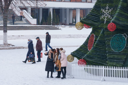 People take pictures and take selfies at the Christmas tree. December 24, 2021 Beltsy Moldova.のeditorial素材