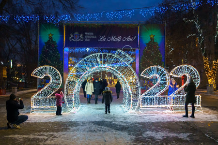 The lights of the night city, decorated with garlands for the Christmas and New Year holidays. December 24, 2021 Balti Moldova.のeditorial素材