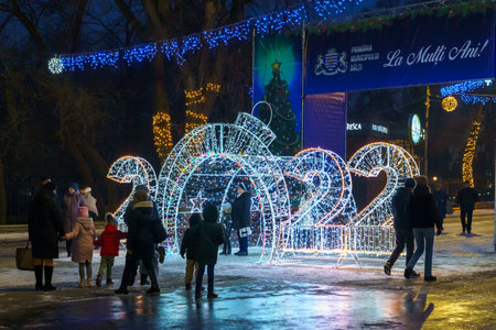 The lights of the night city, decorated with garlands for the Christmas and New Year holidays. December 24, 2021 Balti Moldova.のeditorial素材