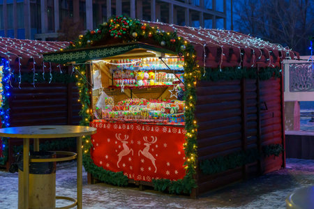 Fair stalls in the New Year or Christmas town. Night background with selective focus and copy space for text or inscription. December 24, 2021 Balti Moldova.のeditorial素材