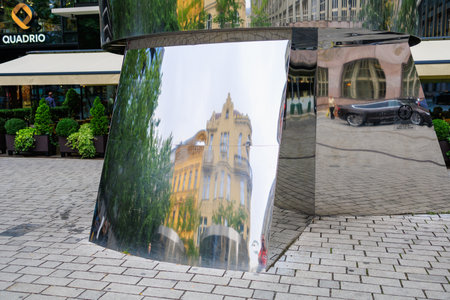 August 25, 2022 Prague, Czech Republic. A modern stainless steel surface that reflects the old building of classical architecture. Background with selective focus and copy space for textのeditorial素材
