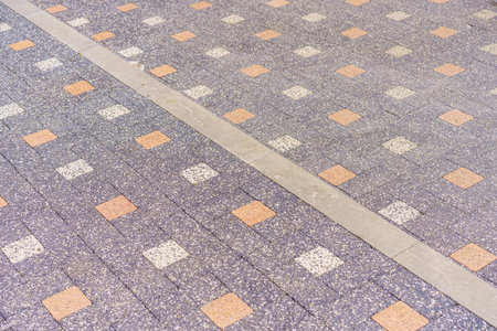 Rough textured paving slab surface with selective focus. Background or backdrop. Design blank or graphic resourceの写真素材