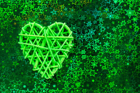Wooden wicker heart. Rattan work in the shape of a heart. Love concept. Background with selective focus and copy space. Holographic backの写真素材