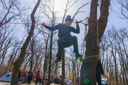 March 27, 2022 Mindrestii Moldova. Tourists amateurs train in the forest to walk on a rope. News...