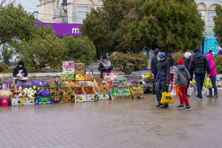 March 8, 2022 Beltsy, Moldova. Street flower trade at the city fair on International Women's Day. Illustrative editorial.のeditorial素材