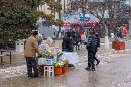 March 8, 2022 Beltsy, Moldova. Street flower trade at the city fair on International Women's Day. Illustrative editorial.のeditorial素材