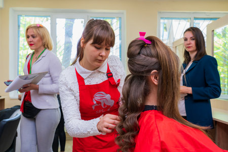 May 17, 2022 Balti Moldova. Hairdresser stylist makes hair styling. Illustrative editorial. Backgroundのeditorial素材