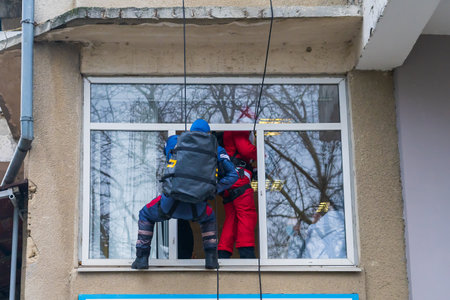 December 27, 2022 Beltsy Moldova. Special forces in holiday costumes of superheroes climb a rope to congratulate childrenのeditorial素材
