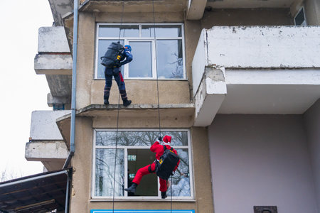 December 27, 2022 Beltsy Moldova. Special forces in holiday costumes of superheroes climb a rope to congratulate childrenのeditorial素材