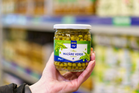 Canned green peas in a glass jar. March 9, 2023 Beltsy, Moldova. For illustrative editorial use.のeditorial素材
