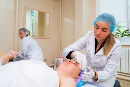 May 17, 2022 Balti Moldova. Beautician performs the procedure. Illustrative editorial. Backgroundのeditorial素材