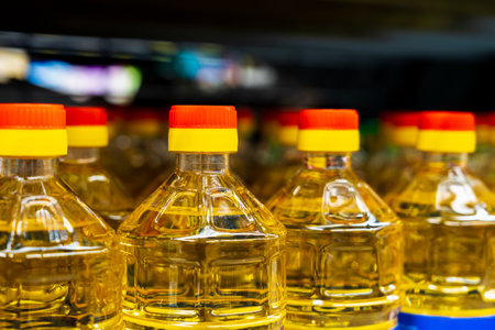 Sunflower oil. The neck of a plastic bottle. Grocery department in a store or market. Background with selective focus and copy spaceの写真素材