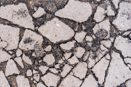 Pits on the road and destroyed asphalt. Background with copy space for textの写真素材