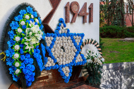 May 19, 2022 Beltsy, Moldova. For illustrative editorial use. Flowers in the form of a six-pointed star at a memorial or monument  in memory of the Jewish victims of Nazismのeditorial素材
