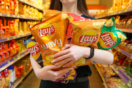 June 8, 2023 Beltsy, Moldova. For illustrative editorial use. Lays chips in handsのeditorial素材