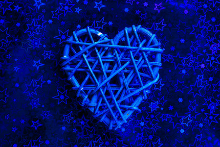 Wooden wicker heart. Rattan work in the shape of a heart. Love concept. Background with selective focus and copy space. Holographic backの写真素材