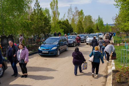 May 1, 2022 Beltsy, Moldova. For illustrative editorial use. People go to the cemetery on funeral...