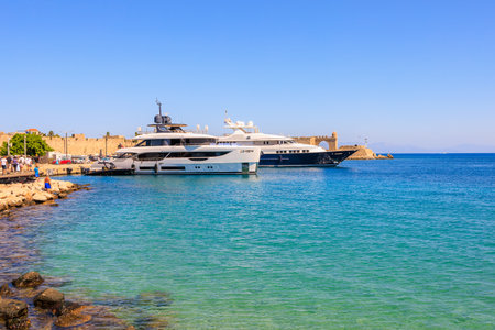 August 7, 2023 Rhodes Greece. For illustrative editorial use. Yachts in the port bay, backgroundのeditorial素材