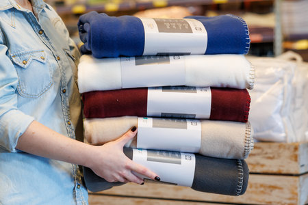 October 11, 2023 Beltsy, Moldova. For illustrative editorial use. Bedspreads in the hands of the seller.のeditorial素材