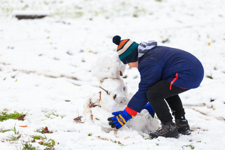 November 20, 2022 Beltsy, Moldova. For illustrative editorial use. Boy making a snowmanのeditorial素材