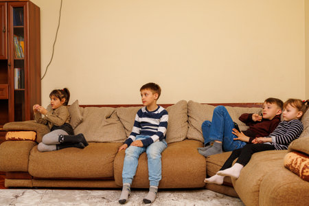 May 3, 2023 Beltsy, Moldova. For illustrative editorial use. Children watching TVのeditorial素材