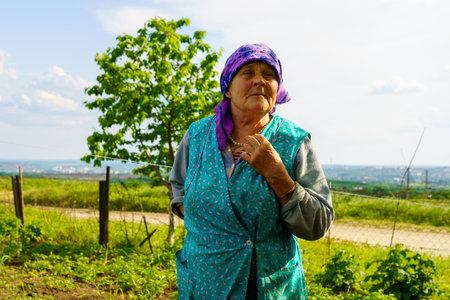 May 23, 2023 Dobruja village, Singerei district, Moldova. For illustrative editorial use. A grandmother in the village talks about the life of farmersのeditorial素材