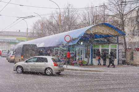 March 8, 2022 Beltsy, Moldova. For illustrative editorial use. Early spring or late autumn in a city with sleetのeditorial素材