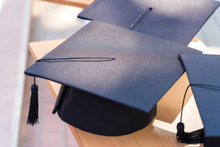 Quadrangular cap as a symbol of a graduate. Background with selective focus and copy space for textの写真素材