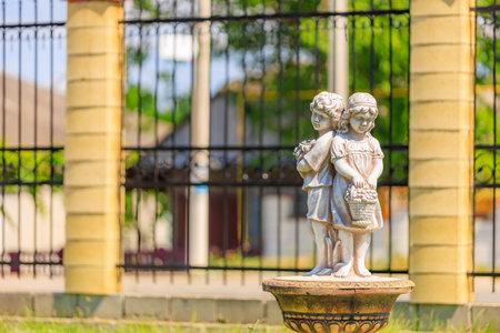Little boy and girl, old sculpture. Background with selective focus and copy space for text.の写真素材