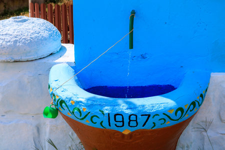 Rural stone washbasin with an inexhaustible spring in 1987. Background with selective focus and copy spaceの写真素材