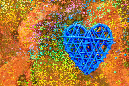 Wooden wicker heart. Rattan work in the shape of a heart. Love concept. Background with selective focus and copy space. Holographic backの写真素材