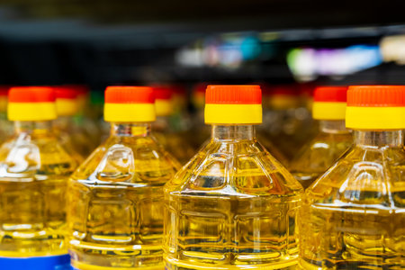 Sunflower oil. The neck of a plastic bottle. Grocery department in a store or market. Background with selective focus and copy spaceの写真素材