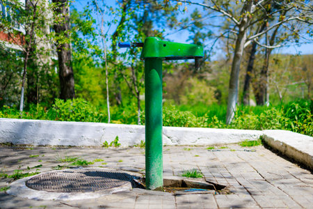 Outdoor pump with drinking water. Background with selective focus and copy space for text