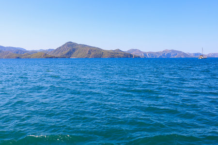 View of mountain landscapes from the sea. Background with selective focus and copy space for textの写真素材