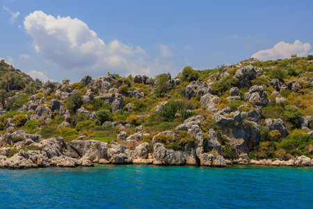 View of the rocky shore from the sea. Background with selective focus and copy space for text. Mediterranean Sea in Turkey. Popular tourist placesの写真素材