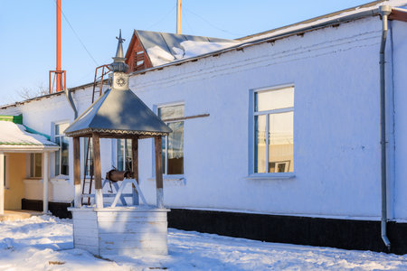 Well in a winter village. Background with selective focus and copy space for textの写真素材