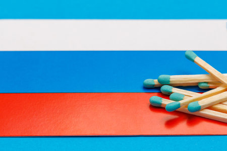 Matches on the background of the flag with selective focus and copy space for textの写真素材