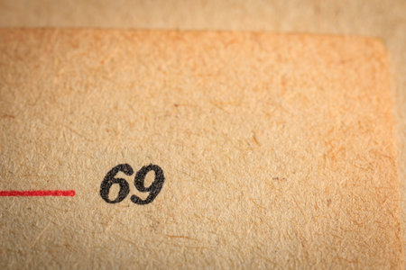 Close-up of page with number 69 printed on textured paper.の写真素材